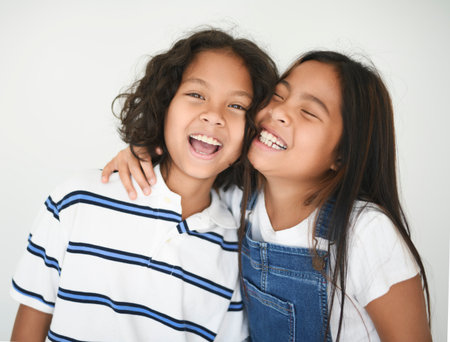 two 9 years thailand twin on studio shot isolated white backgroundの写真素材