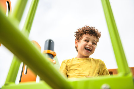 Happy kid on playground on summer seasonの写真素材