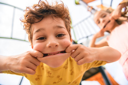 Happy kids on playground in summer seasonの写真素材