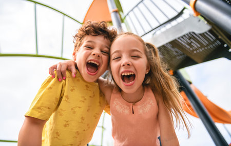 Happy kids on playground in summer seasonの写真素材