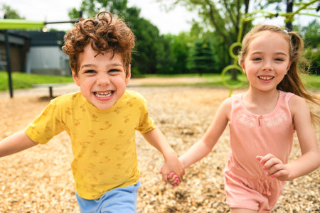 Happy kids on playground in summer seasonの写真素材
