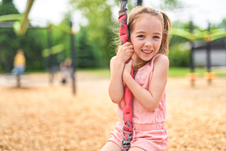 Happy 5 years old girl on a playground