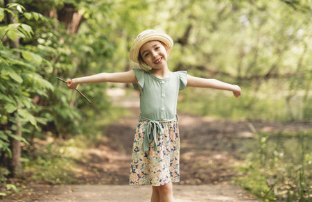 Funny smiling child girl 4-5 year old in park on summer seasonの写真素材