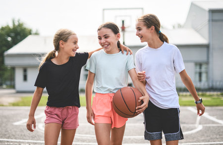 Girls Team in sportswear playing basketball gameの写真素材