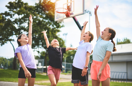 Childs girls Team in sportswear playing basketball game