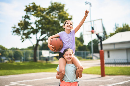 two childs girls in sportswear playing basketball gameの写真素材