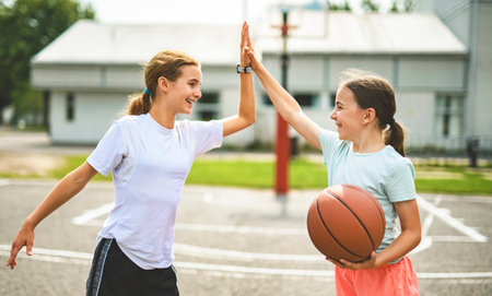 two childs girls in sportswear playing basketball gameの写真素材