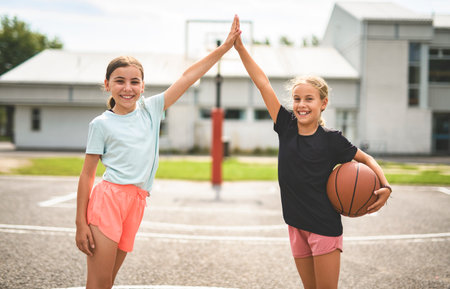 two childs girls in sportswear playing basketball gameの写真素材