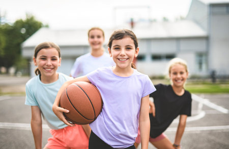 Childs girls Team in sportswear playing basketball game