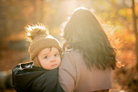 Joyful mother and her little baby. mother and child have fun, laugh and enjoy nature outdoors at autumn park.の写真素材