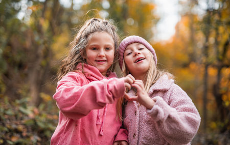 two Young Childrens having fun on Autumn Forest