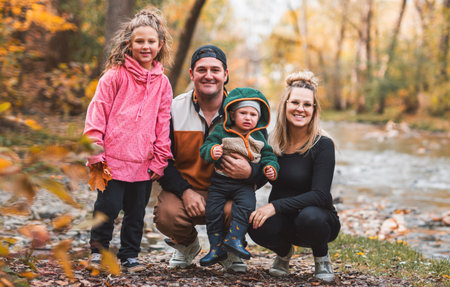 Joyful family in autumn season enjoy nature outdoors at autumn park.の写真素材