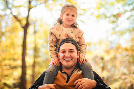 Joyful dad and his little daughter. daddy and child have fun, laugh and enjoy nature outdoors at...