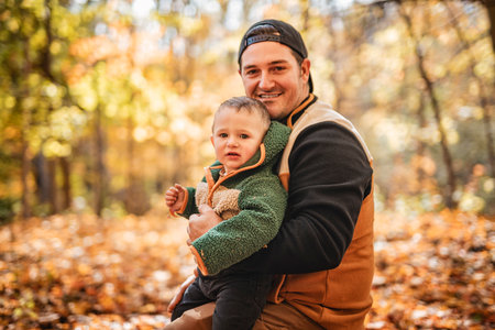 Joyful dad and his little baby. daddy and child have fun, laugh and enjoy nature outdoors at autumn...