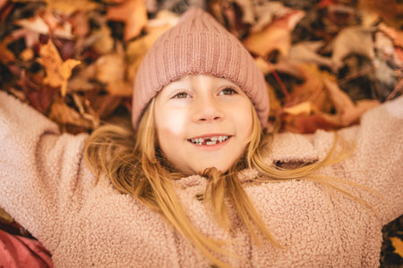 Child girl having fun on Autumn Forest