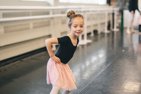 Cute little ballerina having fun on ballet roomの写真素材