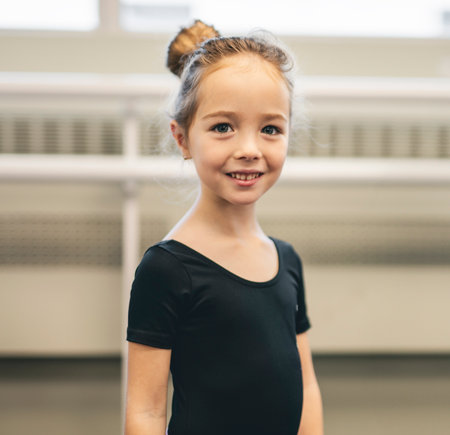 Cute little ballerina having fun on ballet roomの写真素材