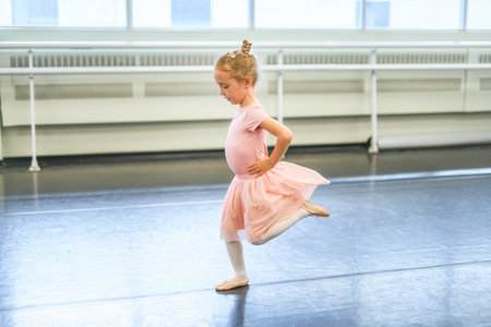 Cute little ballerina having fun on ballet roomの写真素材