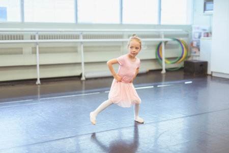 Cute little ballerina having fun on ballet roomの写真素材