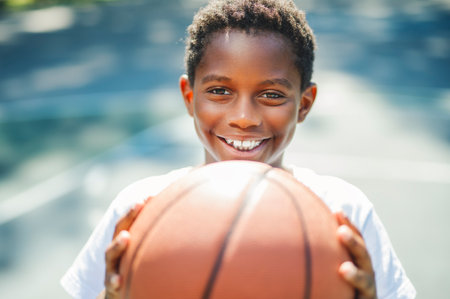 portrait of a boy playing with a basketball in parkの写真素材