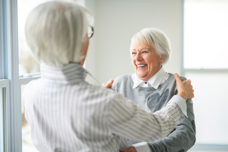 Portrait of two elderly women hugging together