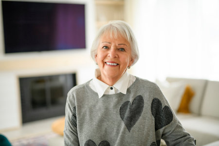 Portrait of elderly woman on living room at homeの写真素材