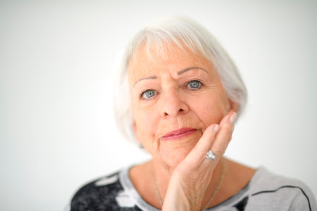 Portrait of elderly woman over grey background.の写真素材