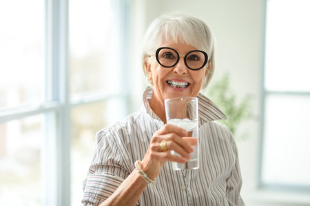 Portrait of elderly woman drinking waterの写真素材