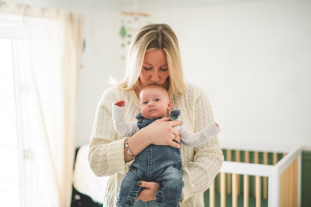 Cute small 1 month baby boy at home. Mother with little newborn infant.の写真素材
