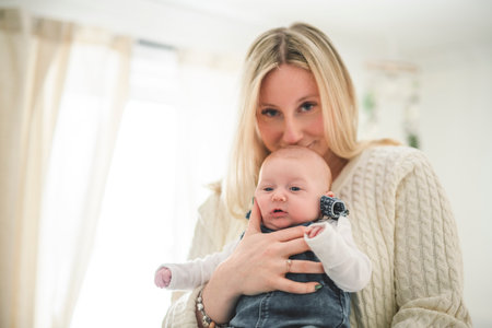 Cute small 1 month baby boy at home. Mother with little newborn infant.の写真素材