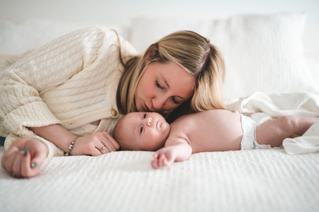 Cute small 1 month baby boy at home. Mother with little newborn infant.