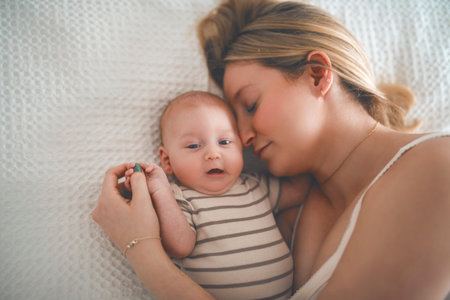 Cute small 1 month baby boy at home. Mother with little newborn infant.の写真素材