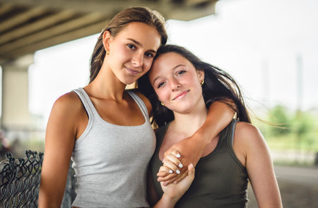 Girlfriends having fun outdoors togerher wearing urban clothesの写真素材