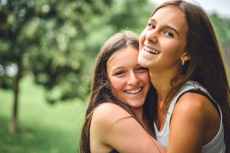 Girlfriends having fun outdoors togerher wearing urban clothesの写真素材
