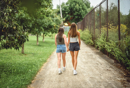 Girlfriends having fun outdoors together wearing urban clothes
