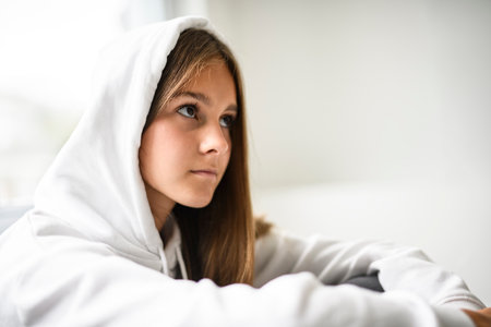 Teen girl on white studio wearing hoodiesの写真素材