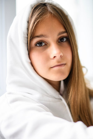 Teen girl on white studio wearing hoodiesの写真素材