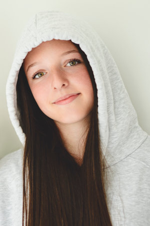 Teen girl on white studio wearing hoodiesの写真素材