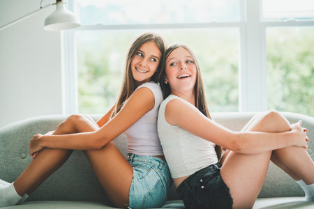 Two best girls having fun together on white studioの写真素材