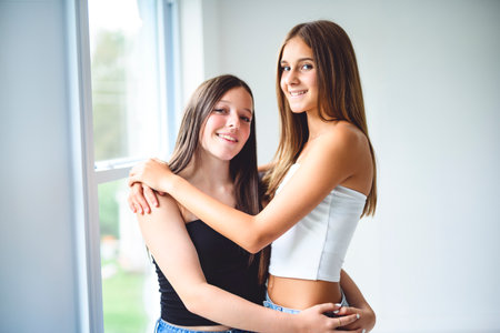 Two best girls having fun together on white studioの写真素材