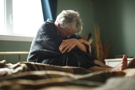 tired senior woman on her bedの写真素材