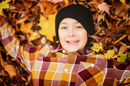 Child boy having fun on Autumn Forestの写真素材