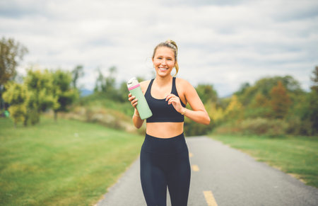 Front view of a happy runner teen doing joggingの写真素材