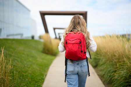 Young girl high school or college student She is on her way to class near university buildingの写真素材