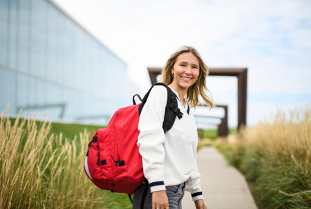 Young girl high school or college student She is on her way to class near university building