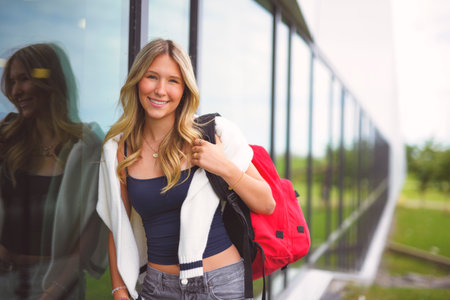 Young girl high school or college student She is on her way to class near university buildingの写真素材