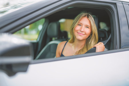A beautiful woman with her new carの写真素材