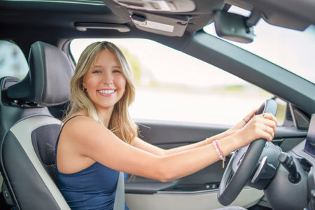 A beautiful woman with her new carの写真素材