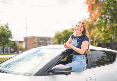 A beautiful woman with her new car sit on door
