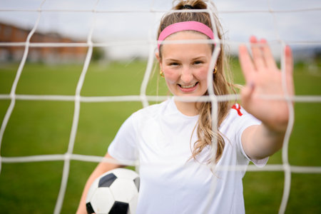 motivation soccer player with a football in a sport uniform wearing in white